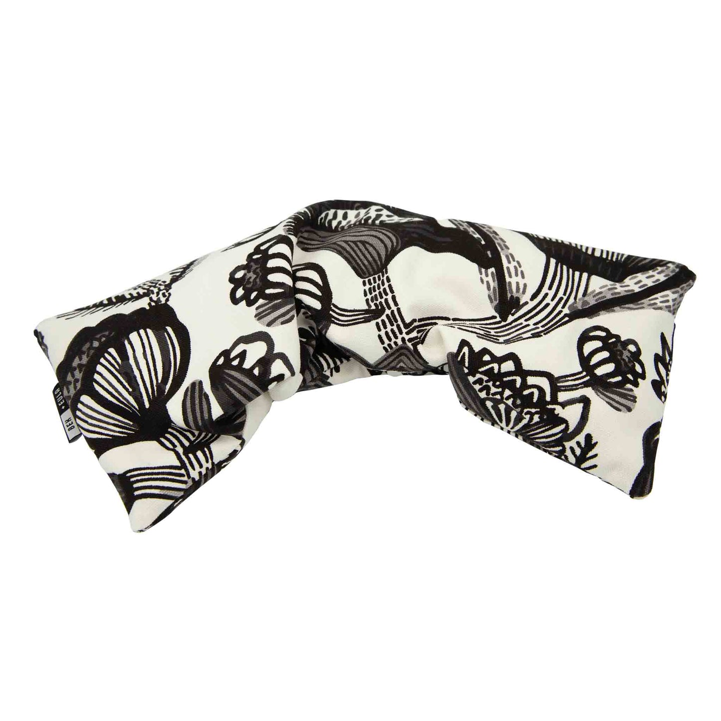 Wheat heat pack, black floral on white, showing extra length